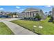 Attractive home features a two-car garage, manicured lawn, and stone-accented entryway at 197 Pineywoods St, St Cloud, FL 34772