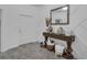 Foyer with stylish wainscoting detail, decorative table with mirror and vases, and tile flooring at 197 Pineywoods St, St Cloud, FL 34772