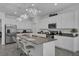 Contemporary kitchen with stainless steel appliances, white cabinetry, island seating, and pendant lighting at 197 Pineywoods St, St Cloud, FL 34772