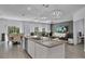 Open-concept living area with pendant lighting, dining table, and comfortable seating near a wall-mounted TV at 197 Pineywoods St, St Cloud, FL 34772