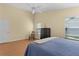 Bright bedroom featuring a ceiling fan, natural light, and wood-look floors at 2186 Quinn Ln, The Villages, FL 32162