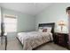 Bedroom featuring a bed, window, ceiling fan, and side table at 2186 Quinn Ln, The Villages, FL 32162