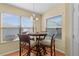 Bright breakfast nook features a round table, cushioned chairs, and natural light from the two large windows at 2186 Quinn Ln, The Villages, FL 32162