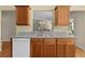 View of the kitchen sink, countertops and cabinets, as well as the pass-through to the living room beyond at 2186 Quinn Ln, The Villages, FL 32162