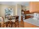 Bright eat-in kitchen featuring laminate floors, wood cabinets, and modern appliances at 2186 Quinn Ln, The Villages, FL 32162