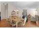 An open floor plan showing the formal dining area leading into the living room space with comfortable seating at 2186 Quinn Ln, The Villages, FL 32162