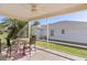 Screened patio with ceiling fan, table and chairs overlooking the lawn and neighborhood at 2186 Quinn Ln, The Villages, FL 32162