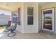 Cozy porch with seating and a stylish tile floor, perfect for relaxing outdoors at 2186 Quinn Ln, The Villages, FL 32162