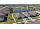 Aerial neighborhood view showcasing a pond, water fountain, and manicured yards at 2897 Sunridge Loop, St Cloud, FL 34771