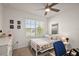 This cozy bedroom features a ceiling fan, decor, and a bright window view at 2897 Sunridge Loop, St Cloud, FL 34771