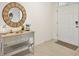 Bright foyer featuring a stylish wood mirror and decorative console table at 2897 Sunridge Loop, St Cloud, FL 34771