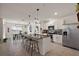 Modern kitchen with an island, stainless steel appliances, and adjacent dining area at 2897 Sunridge Loop, St Cloud, FL 34771