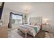 Cozy main bedroom with decorative headboard, bench, chandelier, and a sunlit window at 2897 Sunridge Loop, St Cloud, FL 34771