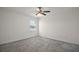 Bedroom with neutral carpet, ceiling fan, and a bright window at 29447 Caspian St, Leesburg, FL 34748