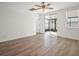 Bright bedroom with wood-look tile, access to a screened lanai, and natural light at 29447 Caspian St, Leesburg, FL 34748