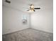 Bedroom with neutral carpet, ceiling fan, and a bright window at 29447 Caspian St, Leesburg, FL 34748