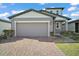 Charming home featuring a spacious two-car garage and brick paver driveway at 29447 Caspian St, Leesburg, FL 34748