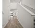 Bright foyer featuring wood-look tile flooring, staircase, and open layout at 29447 Caspian St, Leesburg, FL 34748