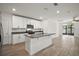 Bright kitchen with white cabinetry, a kitchen island, and stainless steel appliances at 29447 Caspian St, Leesburg, FL 34748