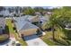 Aerial view of a well maintained home with landscaped yard and concrete driveway at 2982 Lake Huron Ln, Tavares, FL 32778