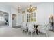 Elegant dining area with natural light, modern light fixture and open to the kitchen at 2982 Lake Huron Ln, Tavares, FL 32778