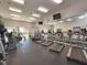 Well-equipped fitness center featuring modern treadmills, exercise equipment, mirrors, and ample natural light at 2982 Lake Huron Ln, Tavares, FL 32778