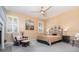 Serene main bedroom with neutral walls, ceiling fan, and two windows providing plenty of natural light at 2982 Lake Huron Ln, Tavares, FL 32778