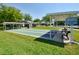 Outdoor shuffleboard courts in a well-kept community recreational area surrounded by lush green grass and trees at 2982 Lake Huron Ln, Tavares, FL 32778