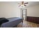 Cozy bedroom features a ceiling fan and wood-look flooring at 34448 Tuscany Ave, Sorrento, FL 32776