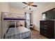 Bedroom with a bunk bed and a TV, featuring hardwood floors and a ceiling fan at 34448 Tuscany Ave, Sorrento, FL 32776