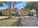 Attractive single-story home with a two-car garage and lush landscaping at 34448 Tuscany Ave, Sorrento, FL 32776