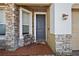 Inviting front porch with stone accents and a cozy seating area at 34448 Tuscany Ave, Sorrento, FL 32776