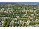 Panoramic aerial view showcasing the neighborhood with a lake in the distance at 3603 Eversholt St, Clermont, FL 34711