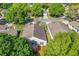 Aerial view of the home's backyard with a screened-in porch, lush green lawn, and trees at 3603 Eversholt St, Clermont, FL 34711