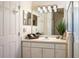 Bathroom features a single sink vanity, a mirror, and a glass-enclosed shower at 3603 Eversholt St, Clermont, FL 34711