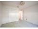 A clean bedroom with neutral carpet features a closet and doorway leading to another room at 3603 Eversholt St, Clermont, FL 34711