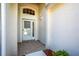 Inviting front porch area with a decorative tile floor and an arched window above the door at 3603 Eversholt St, Clermont, FL 34711