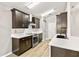 Modern kitchen with stainless steel appliances, white countertops, and dark cabinets at 3603 Eversholt St, Clermont, FL 34711