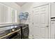 Laundry room with Samsung front load washer and dryer and shelving at 3603 Eversholt St, Clermont, FL 34711