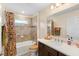 Well-lit bathroom with a modern vanity, a shower/tub combo with a stylish curtain, and coordinated accessories at 3666 Arlington Ridge Blvd, Leesburg, FL 34748