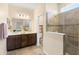 Elegant bathroom showcasing a vanity, a tiled shower with glass partition, and a separate toilet area at 3666 Arlington Ridge Blvd, Leesburg, FL 34748