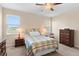 Cozy bedroom featuring two windows, a ceiling fan, and comfortable traditional furnishings at 3666 Arlington Ridge Blvd, Leesburg, FL 34748