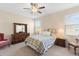 Bright bedroom with ceiling fan, two windows, and a traditional furniture set, creating a cozy space at 3666 Arlington Ridge Blvd, Leesburg, FL 34748