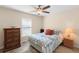 Comfortable bedroom with two windows, an area rug, and traditional furnishings for a cozy and restful atmosphere at 3666 Arlington Ridge Blvd, Leesburg, FL 34748