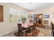 Dining area with a wooden table, seating for six, and a large window at 3666 Arlington Ridge Blvd, Leesburg, FL 34748