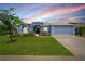 Charming single-story home with a well-manicured lawn and attractive blue exterior at 3666 Arlington Ridge Blvd, Leesburg, FL 34748