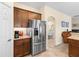 Modern kitchen featuring stainless steel refrigerator and granite countertops at 3666 Arlington Ridge Blvd, Leesburg, FL 34748