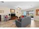 Comfortable living room with tile floors, ceiling fan, and sliding glass doors to the lanai at 3666 Arlington Ridge Blvd, Leesburg, FL 34748