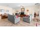 Inviting living room featuring tile floors, neutral walls, and comfortable seating arrangement with a ceiling fan at 3666 Arlington Ridge Blvd, Leesburg, FL 34748