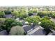 Wide aerial shot of the neighborhood, featuring mature trees and well-spaced homes at 3827 Westerham Dr, Clermont, FL 34711